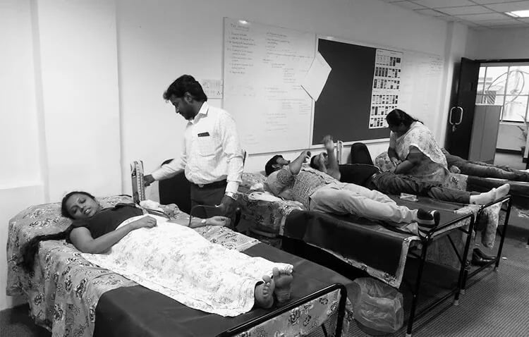 Few patients lying on different beds and going through a blood drive